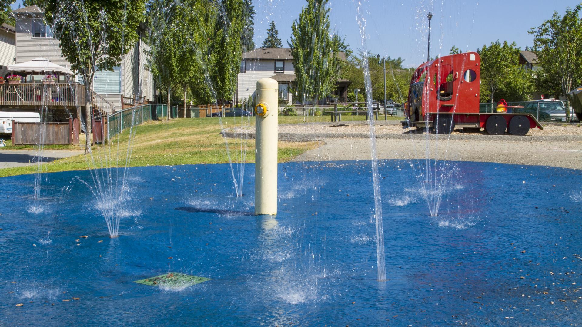A blue circular surface with several fountains spraying up. 